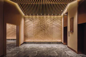 Modern hotel lobby featuring metal, glass, and marble materials.