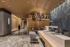 Modern hotel reception area featuring wood cladding, marble accents, and cement floors.