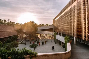 Outdoor urban space with modern wooden structures and concrete flooring.