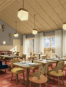 A warmly lit restaurant dining area with wooden tables and chairs, fabric cushions, and glassware.