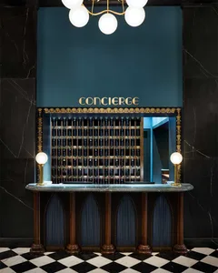 A luxurious hotel concierge desk with a marble countertop and a sign reading 'CONCIERGE'.