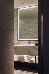 Modern bathroom with marble fixtures and a large mirror.