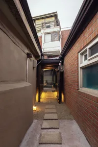 A minimalist urban alleyway with brick walls and concrete pavers