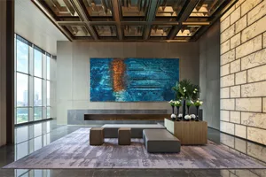 Modern lobby interior featuring luxurious marble finishes, contemporary furniture, and large abstract art on the wall, creati