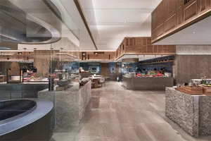 Modern restaurant interior with marble counters and contemporary design elements.