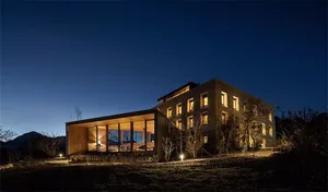 Modern residential exterior with wooden elements and night sky background
