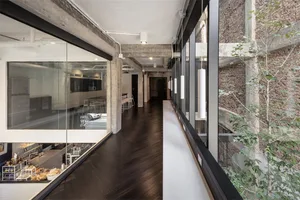 Industrial-style coffee and bakery shop with concrete, glass, and brick wall.