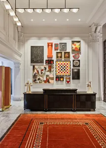 A modern lobby designed with metal, wood, and marble materials.