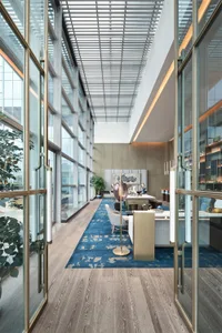 Modern office space interior featuring wooden tiles on the floor and walls, with a clean and contemporary design.
