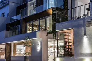 A modern restaurant with concrete and glass exterior features.