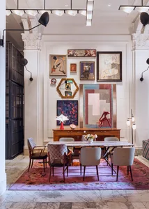 The image depicts a modern restaurant interior with marble flooring, a wooden dining table, upholstered chairs, metal accents