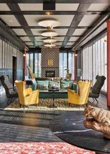 Modern living room featuring wood, fabric, glass, and metal elements.