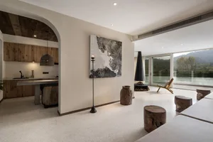 Modern minimalist living room with wood, concrete, and glass elements