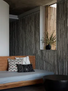 Minimalist bedroom with concrete wall and wooden bed frame