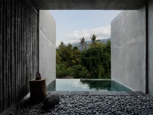 A modern spa setting with concrete and stone elements providing a serene and tranquil environment.