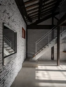 Minimalist interior with concrete, white brick, and steel elements