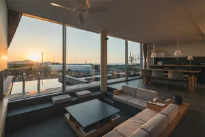 Modern residential living room featuring concrete and glass materials.
