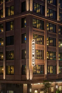 A well-lit building exterior featuring a signage with the text 'the CHOW KIT'.