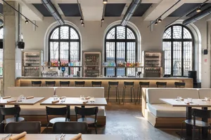 Modern restaurant interior with concrete and glass features