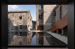 Urban renovation featuring a tranquil water feature surrounded by historic buildings.