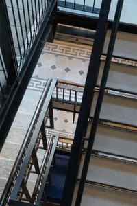 Modern staircase featuring metal railings and concrete steps