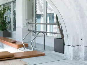 Industrial-style interior with metal railing and tiled floor.