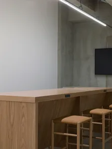 A wooden modern bar counter in a contemporary setting.