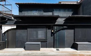 A modern retail storefront with concrete, metal, and wooden elements.