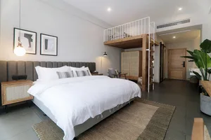 A minimalist bedroom featuring wood, concrete, and metal materials