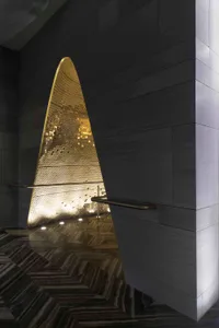 A sleek, modern interior design featuring metallic tiles and concrete