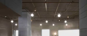 A modern office lobby features a minimalist design with metal wire ceiling lights.