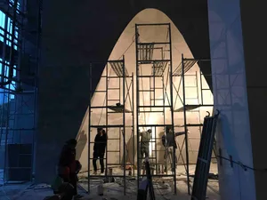 Construction workers setting up scaffolding on a building site.