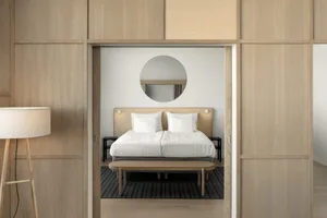 A modern bedroom with a bamboo bed and minimalistic decor.