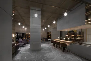 現代酒店酒吧，設有混凝土休息區，搭配當代座椅配置與精緻設計。