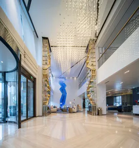 A modern hotel lobby with glass fixtures and elegant lighting features.