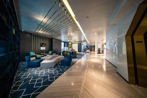 A modern hotel lobby featuring marble and concrete materials.