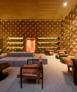 Modern lobby interior with textured wooden walls, leather seating, and muted color palette.
