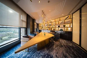 A modern office space featuring a stainless steel table in a contemporary setting.