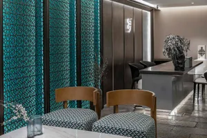 Modern, minimalist restaurant interior with metallic glass panel walls