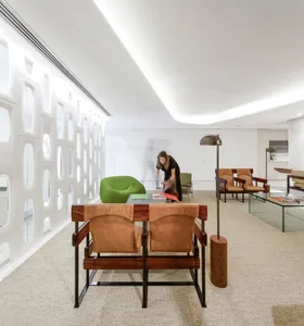A modern office space featuring natural leather and wooden furniture.