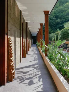 A scenic corridor lined with stone walls and concrete walkway.