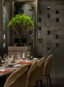 Modern dining room with concrete walls and minimalist furniture.