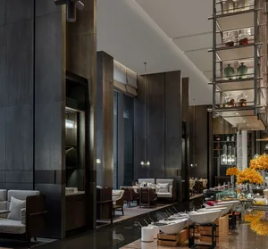 A modern restaurant with concrete, glass, and wooden elements.