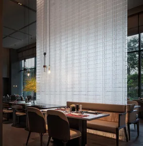Modern restaurant interior with glass wall and upholstered seating