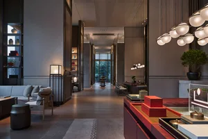 A minimalist hotel lobby featuring modern furniture and lighting.