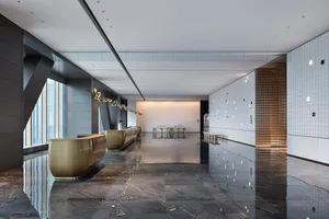 Modern hotel lobby featuring marble and metal surfaces.