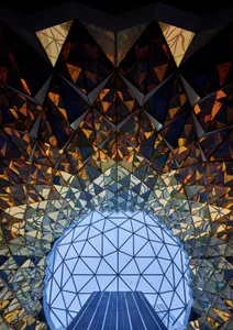 A modern interior design featuring glass and metallic elements