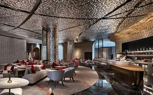 Modern lounge area with metallic textured ceiling, contemporary furniture, and a bar counter.