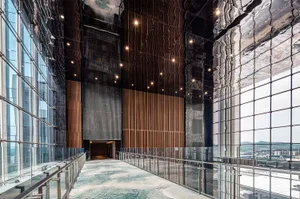 Modern office building interior with wooden panels and glass walls.