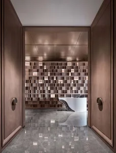 Modern reception area with wooden paneling and a white curved reception desk.